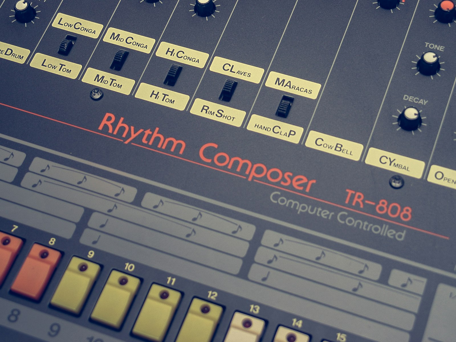 Close up of a Roland TR-808 Rhythm Composer, its numbered step buttons running along the bottom edge